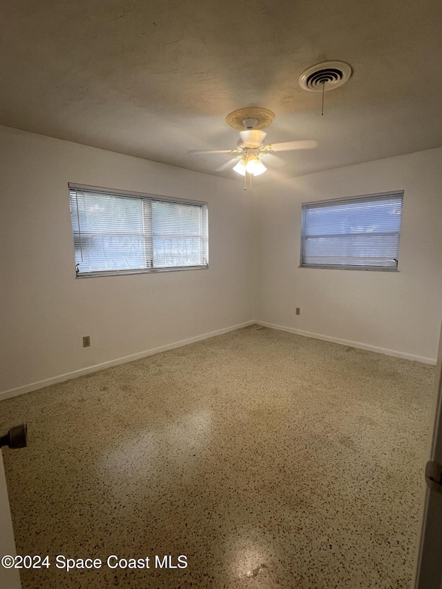 spare room with ceiling fan