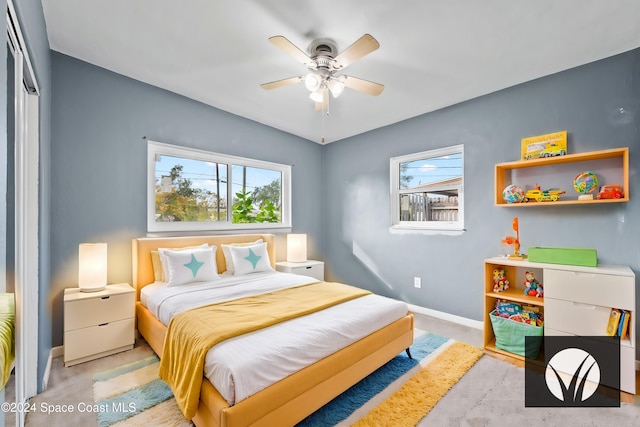 bedroom with ceiling fan, a closet, and multiple windows