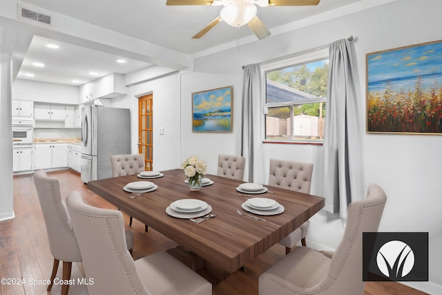 dining area featuring ceiling fan, hardwood / wood-style floors, and crown molding