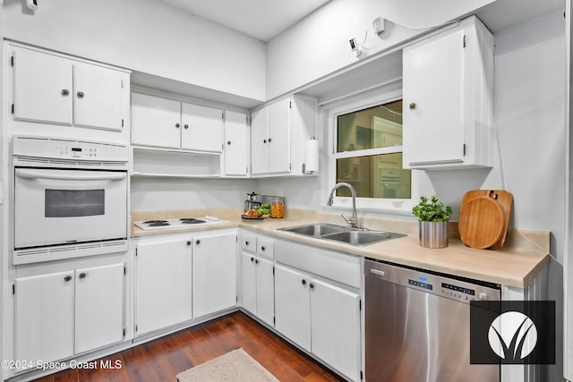 kitchen with white cabinetry, sink, dark hardwood / wood-style floors, and white appliances