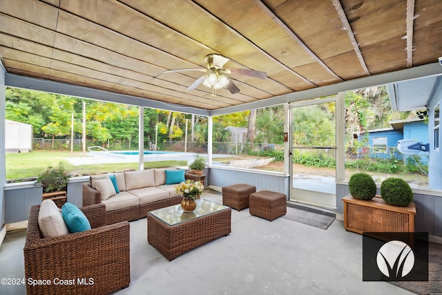 sunroom featuring ceiling fan and wood ceiling