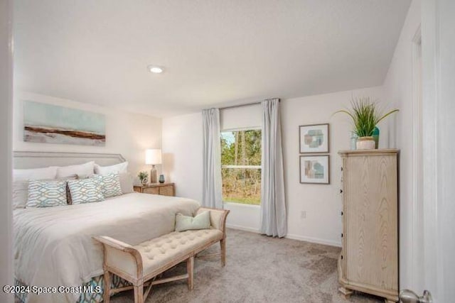 bedroom featuring baseboards and light carpet