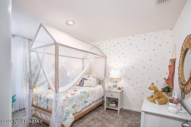 bedroom with baseboards, visible vents, carpet flooring, and wallpapered walls