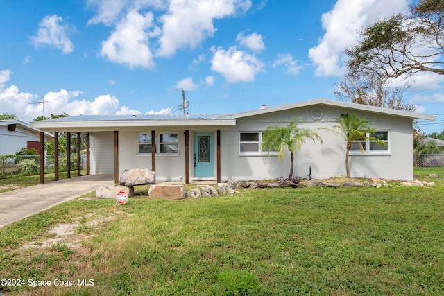 single story home featuring a front lawn and a carport