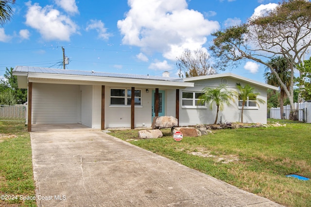 ranch-style home with a carport and a front lawn