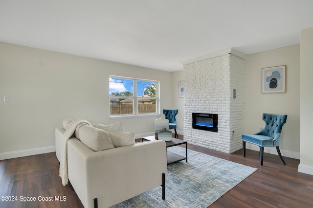 living room with dark hardwood / wood-style floors and a brick fireplace