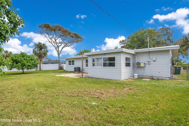 back of property featuring central air condition unit, a patio area, and a lawn