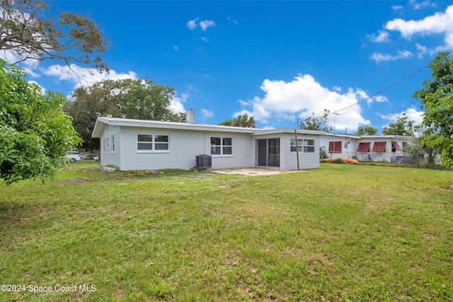 1610 Glen Haven Dr, Merritt Island, FL 32952 - rear view of property with a chimney, a patio area, and cooling unit