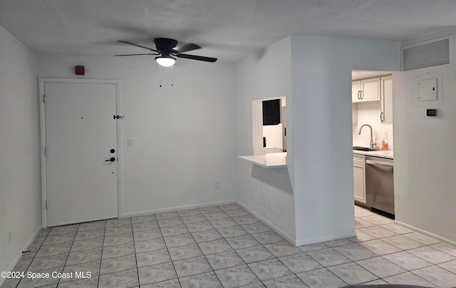 interior space with a textured ceiling, sink, and ceiling fan