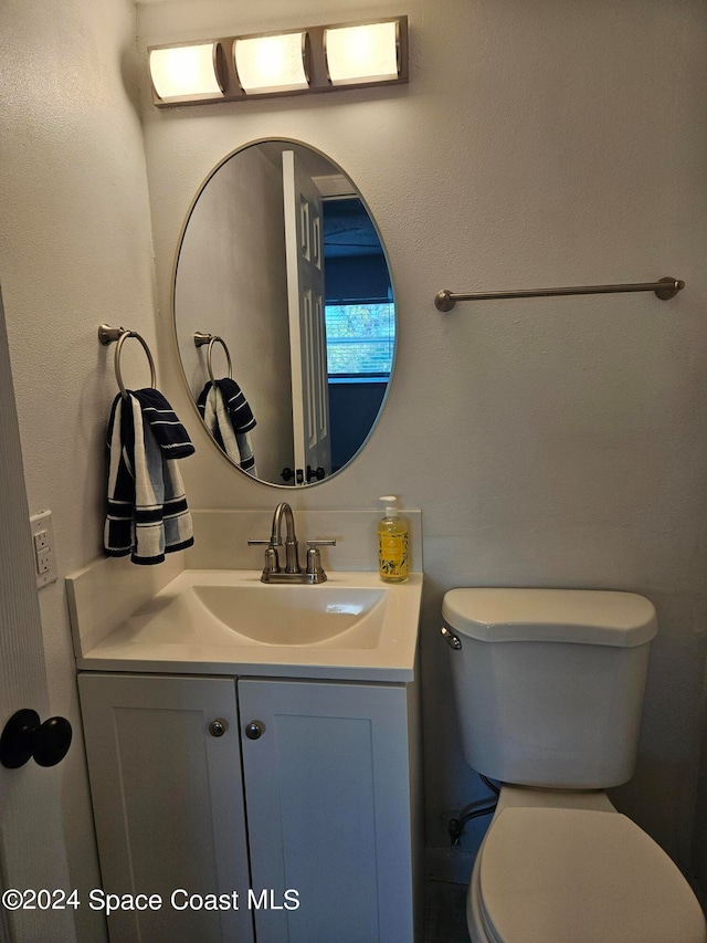 bathroom with toilet and vanity