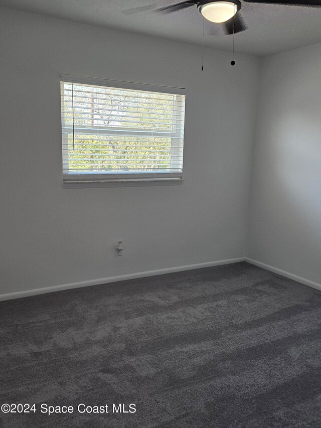 carpeted empty room featuring a textured ceiling and ceiling fan