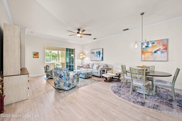 living room with crown molding, light wood-type flooring, and ceiling fan