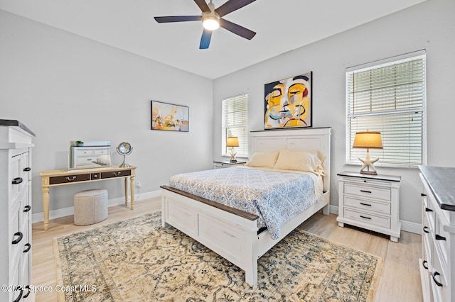 bedroom with light hardwood / wood-style floors, multiple windows, and ceiling fan