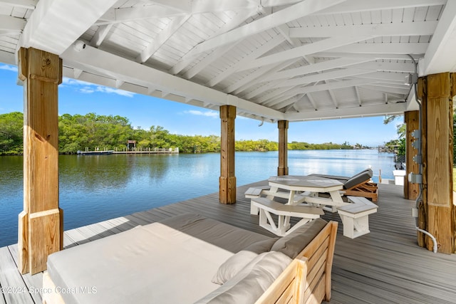 view of dock with a gazebo, a water view, and outdoor lounge area