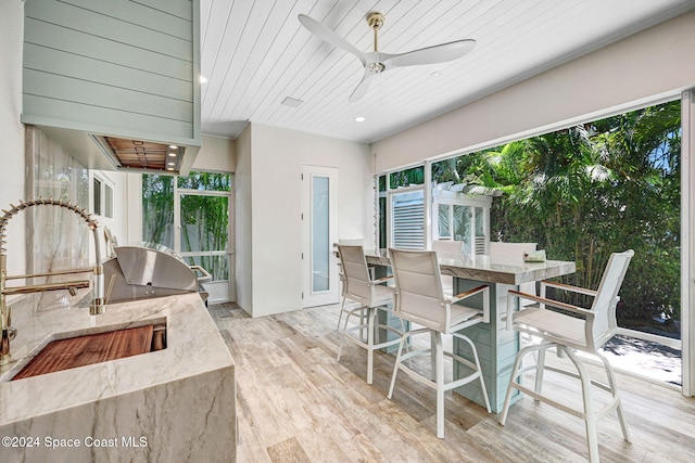 exterior space featuring ceiling fan, wooden ceiling, and sink