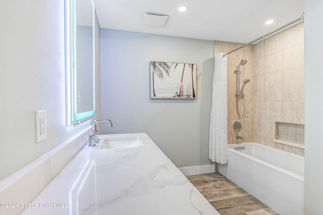 bathroom with vanity, wood-type flooring, and shower / tub combo with curtain