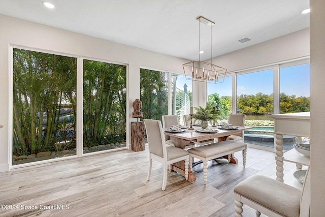 sunroom featuring an inviting chandelier