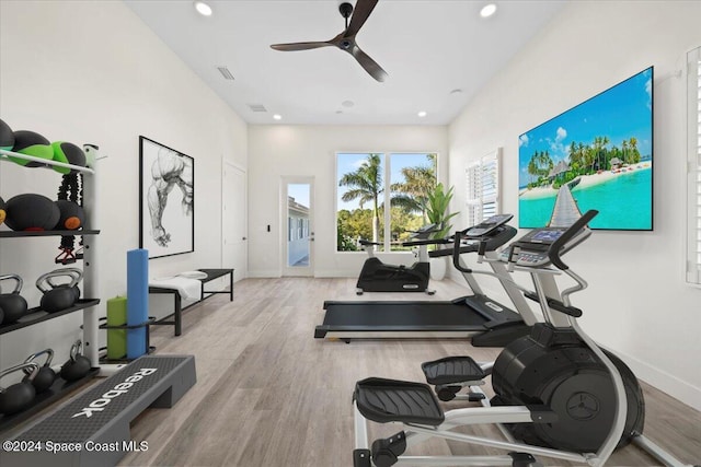 workout area featuring ceiling fan and light wood-type flooring