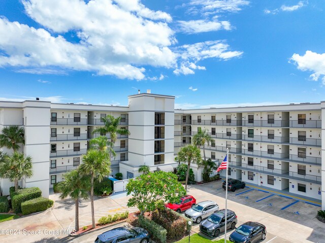 7400 Ridgewood Ave Unit 105, Cape Canaveral, FL 32920 - view of apartment building / complex with uncovered parking