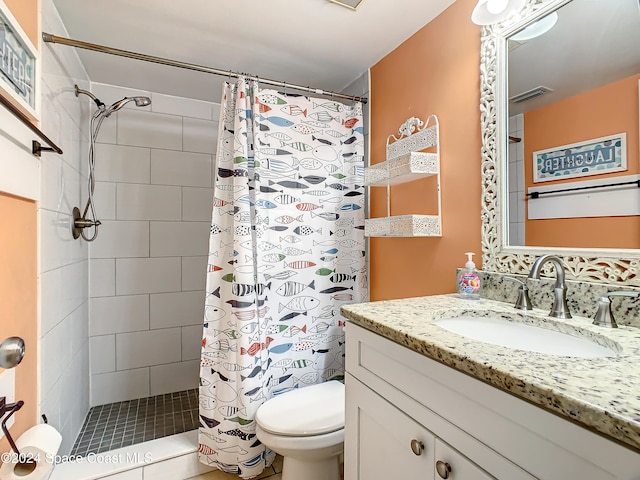 bathroom featuring a shower with curtain, vanity, and toilet