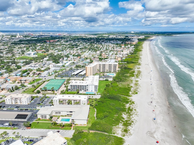 aerial view with a water view and a beach view