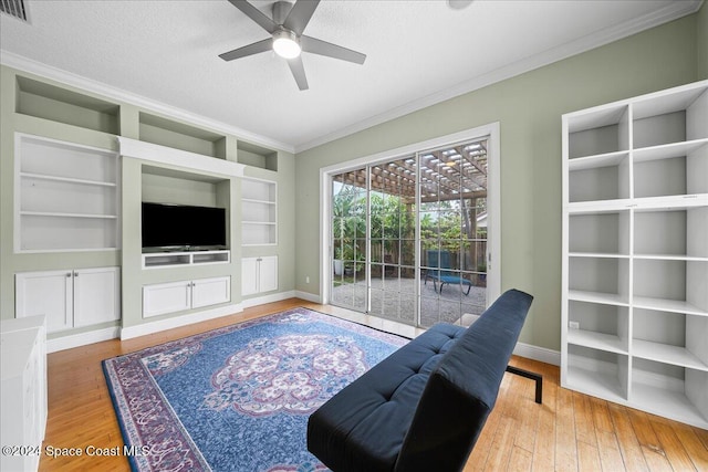 living room featuring crown molding, ceiling fan, a textured ceiling, and hardwood / wood-style flooring