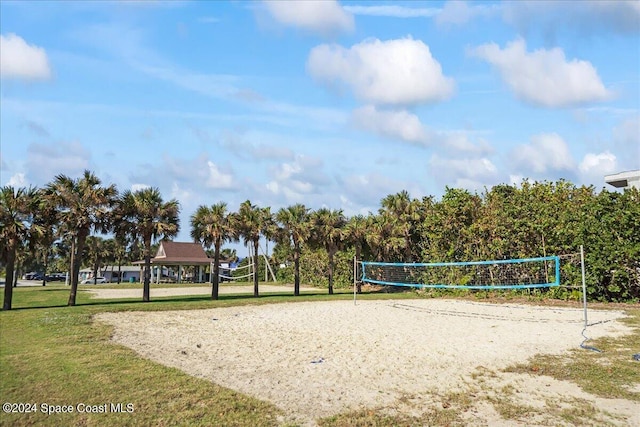 view of community featuring volleyball court and a yard