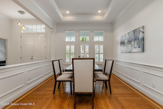 dining area with recessed lighting, a decorative wall, parquet floors, ornamental molding, and a tray ceiling