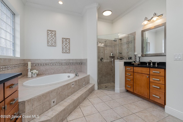 full bathroom featuring tile patterned floors, crown molding, vanity, a shower stall, and a bath