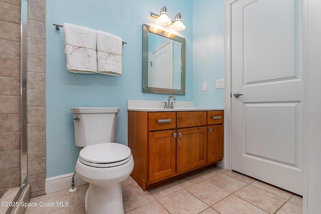 full bath with tile patterned floors, toilet, vanity, baseboards, and walk in shower