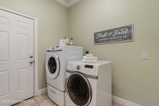 washroom with laundry area, light tile patterned floors, baseboards, and separate washer and dryer