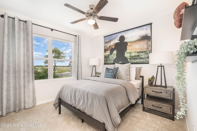 bedroom featuring light carpet and ceiling fan