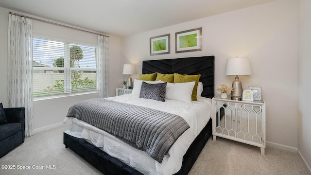 bedroom featuring light carpet