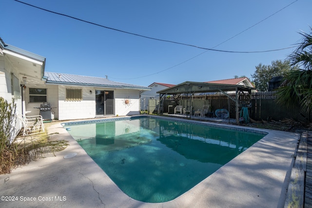 view of swimming pool with a patio area, a gazebo, and a grill