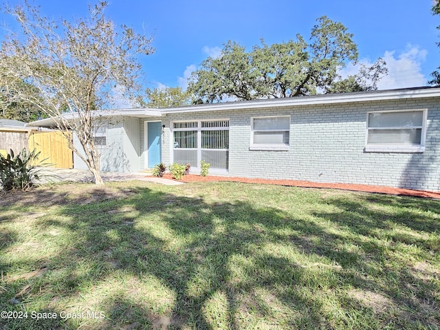 rear view of property featuring a yard