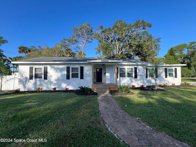 ranch-style home with a front lawn