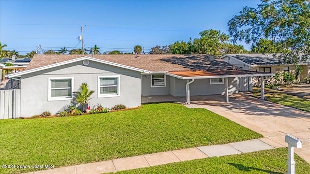 ranch-style home with a front yard and a carport