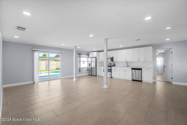 unfurnished living room featuring sink