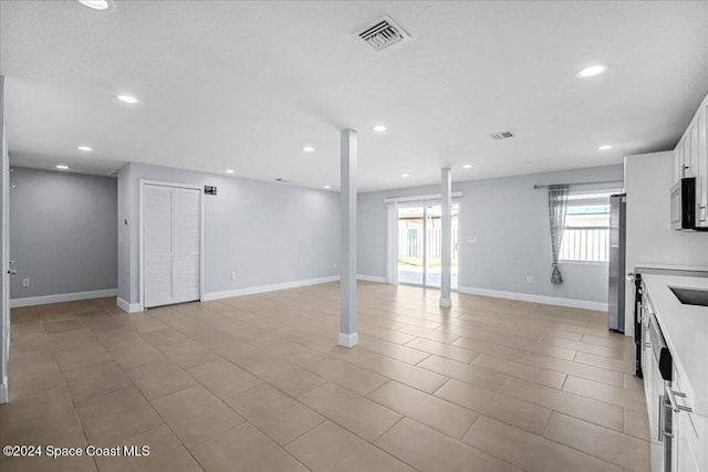 interior space with a wealth of natural light and stainless steel fridge