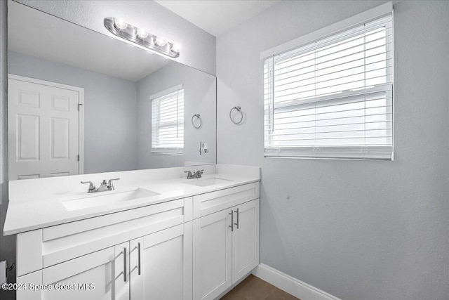 1500 Dorsal St, Merritt Island, FL 32952 - bathroom featuring baseboards and double vanity