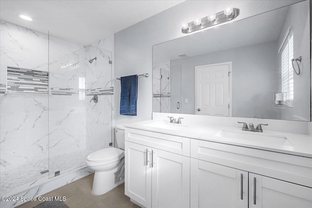 bathroom featuring vanity, toilet, and an enclosed shower