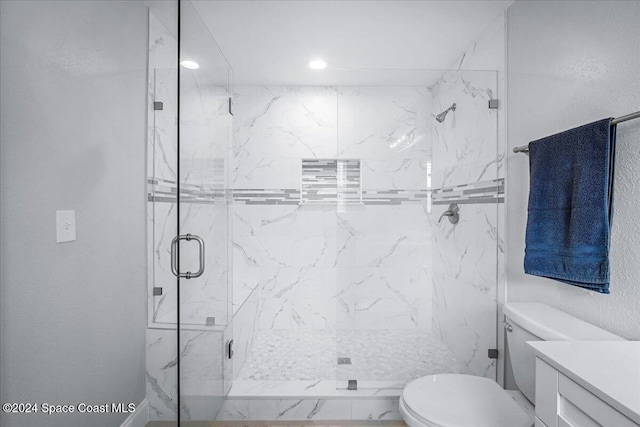 bathroom with vanity, toilet, and an enclosed shower