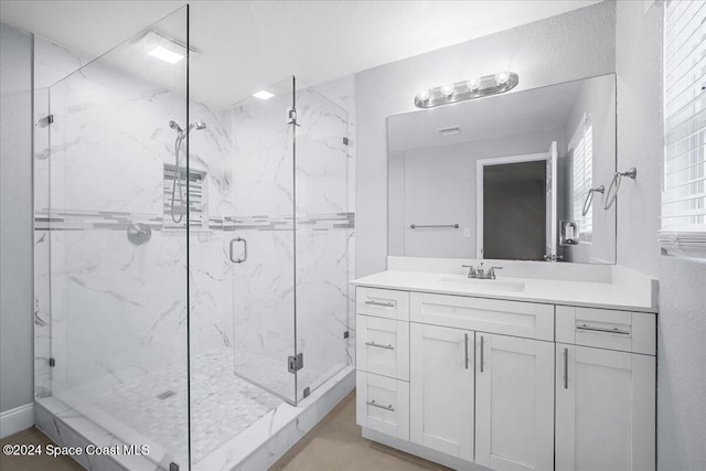 bathroom featuring vanity and an enclosed shower