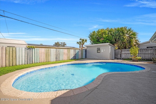 view of swimming pool featuring a storage unit and a patio