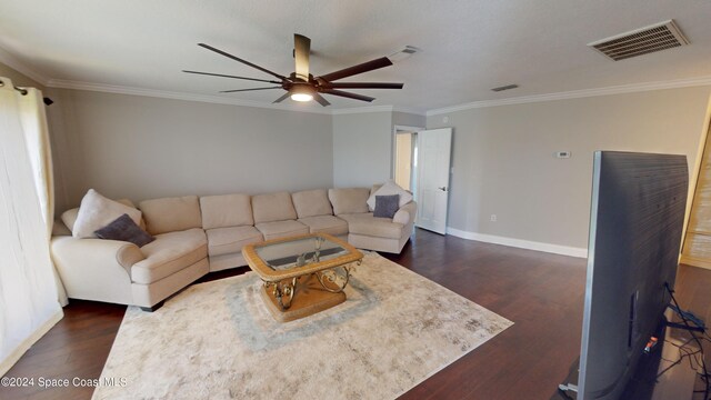 living room featuring crown molding, ceiling fan, and dark hardwood / wood-style flooring