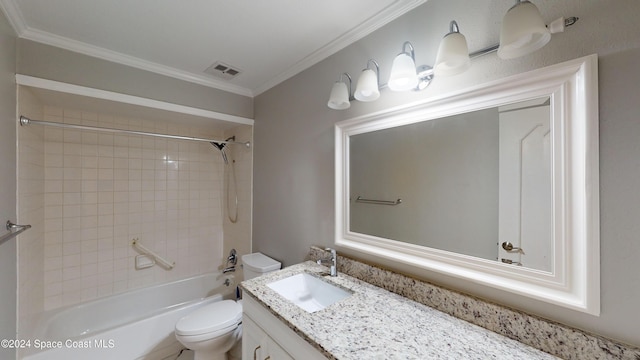 full bathroom with vanity, toilet, crown molding, and tiled shower / bath combo