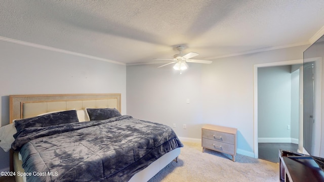 bedroom with crown molding, a textured ceiling, light colored carpet, and ceiling fan