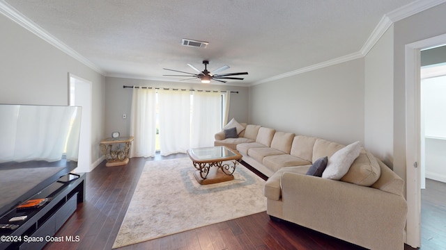 living room featuring ornamental molding, dark hardwood / wood-style floors, a healthy amount of sunlight, and ceiling fan