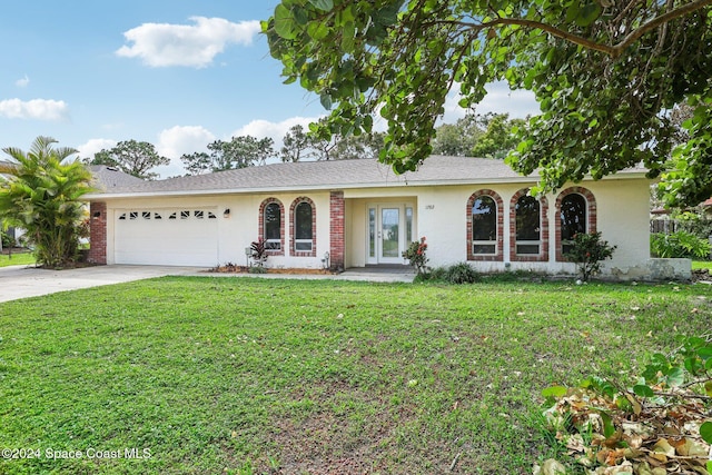 view of front facade with an attached garage, a front lawn, driveway, and brick siding