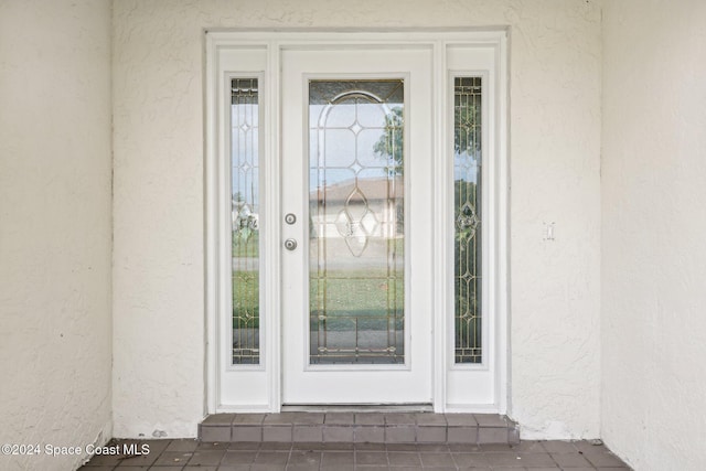 property entrance featuring stucco siding